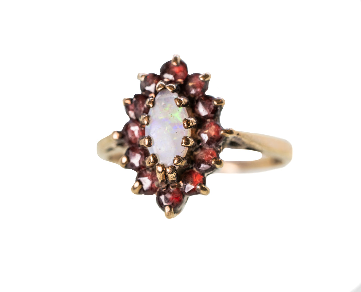Oval Opal with Garnet Halo in 9ct Yellow Gold Ring